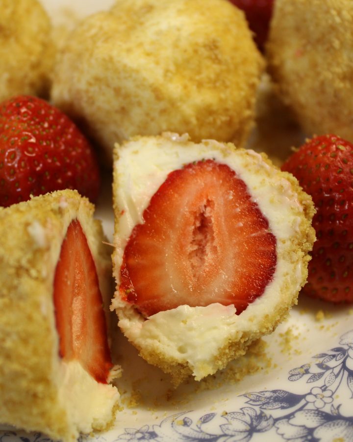 strawberry wrapped in cheesecake and coated in crushed graham crackers